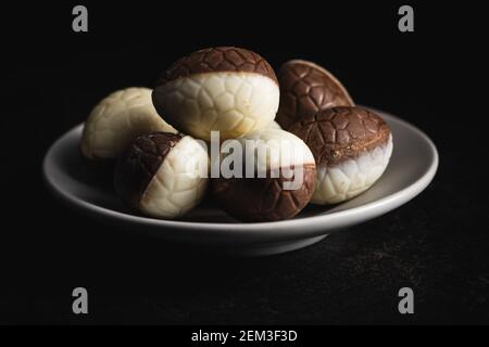 Chocolate easter eggs. Sweet candy eggs on a plate. Stock Photo