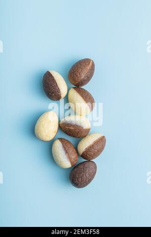 Chocolate easter eggs. Sweet candy eggs on a blue background. Top view. Stock Photo