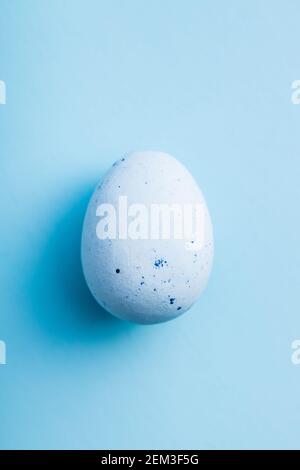 Blue chocolate easter egg. Sweet candy egg on a blue background. Top view. Stock Photo
