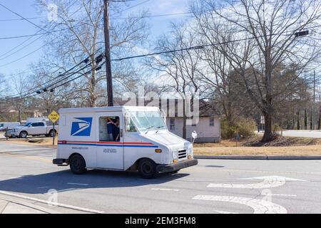 Buford, Georgia - Jan 20th 2021: United States Postal Service van delivering mail in Buford, Georgia Stock Photo