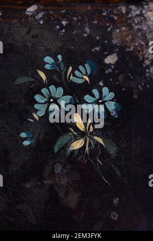 Blue flowers painted on black, ancient background Stock Photo