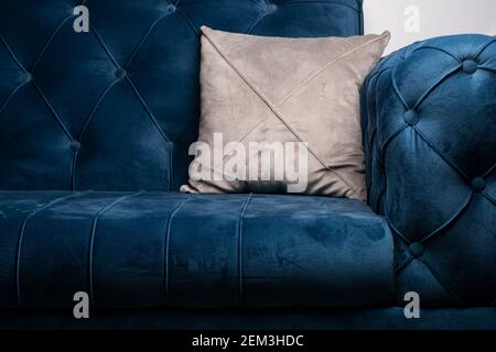 Blue velvet sofa with gray cushion, modern sofa texture with sunken buttons Stock Photo