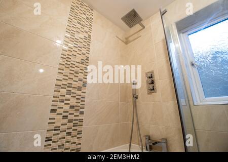 A brand new modern British home showing a modern new shower fitted with a square shower head Stock Photo