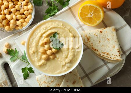 Concept of tasty eat with bowl of hummus, top view Stock Photo