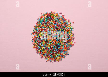 Egg made of sprinkles on pink background Stock Photo