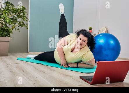 Young Plus Size Woman Stretching Body on Fitness Mat Warming Up Legs  Muscles Stock Photo - Image of adult, overweight: 227832460