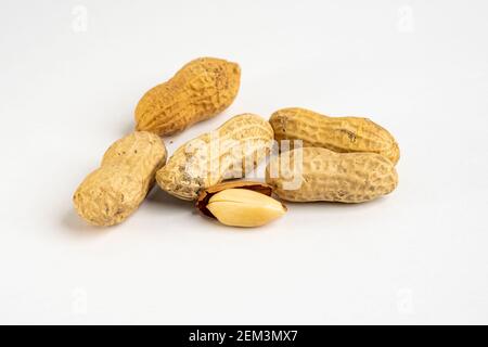 Heap of raw peanuts in shells without salt close up detail on neutral background Stock Photo