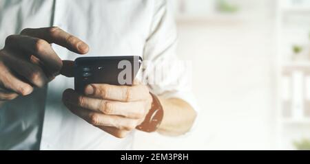 business man using smart phone in office. communication and technology concept. banner copy space Stock Photo