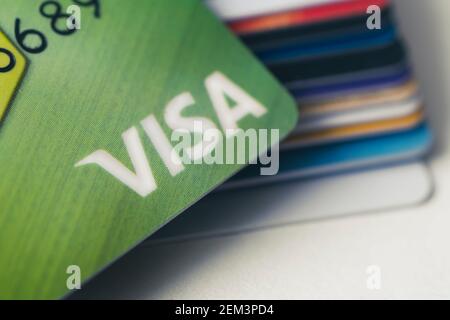 20 February 2021, Barnaul, Russia: Pile of VISA card, credit cards on the white table. shallow focus in soft tone. business concept. Stock Photo