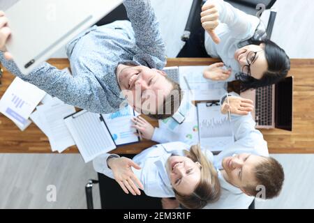 Businessmen are filming video on tablet at their desk Stock Photo