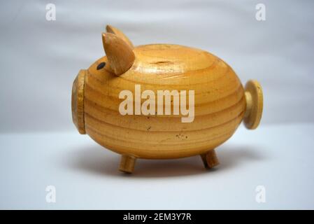 Ukrainian hodgepodge made of natural wood, hand made in the shape of a pig and located on a white background. Stock Photo