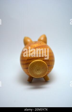 Ukrainian hodgepodge made of natural wood, hand made in the shape of a pig and located on a white background. Stock Photo