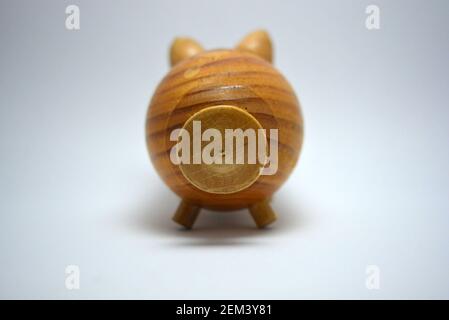 Ukrainian hodgepodge made of natural wood, hand made in the shape of a pig and located on a white background. Stock Photo
