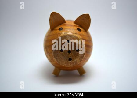 Ukrainian hodgepodge made of natural wood, hand made in the shape of a pig and located on a white background. Stock Photo