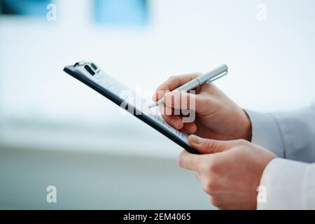 close-up. doctor filling out a medical form. Stock Photo