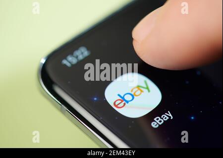 New york, USA - February 24, 2021: Ebay app on smartphone screen touch with finger macro close up view Stock Photo