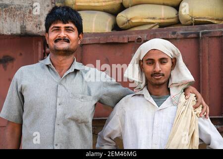 Portrait of manual workers employed to move bags of cement at railway junction in Mathura, Uttar Pradesh, India. Stock Photo