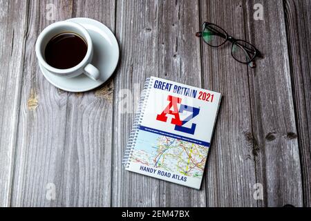 An open A to Z road map laid on a wooden table, a journey planning concept Stock Photo