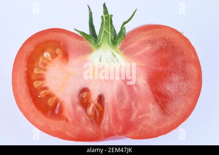 Beefsteak tomato cut in half  Solanum lycopersicum  Syn.  Lycopersicon esculentum Stock Photo