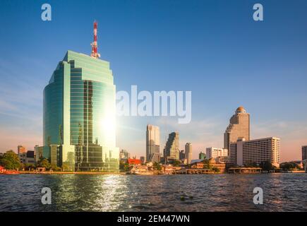 Bangkok Skyline as Seen from the Eastern Chao Phraya River Embankment at Sunset Stock Photo