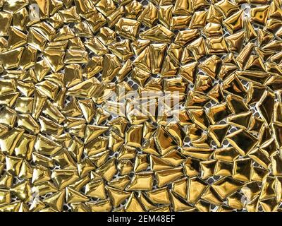 Golden art background from mirror shiny and glossy mosaic for interior design. Abstract glass gold wall with geometric pattern. Decorative tile. Stock Photo