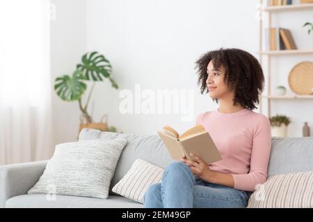 Serene pretty young african american woman feel relaxed, lady dream enjoy wellbeing breathing fresh air Stock Photo