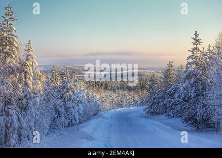 View over winter road to Lake Lillholmstrasket in Sweden, seen from Amliden. Stock Photo