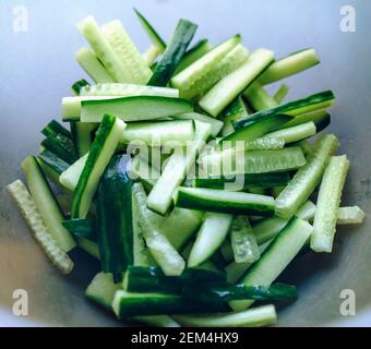 close up view of freshly cut pieces of cucumbers in the bowl Stock Photo