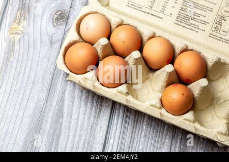 A Box of British eggs in an egg box on a wooden table Stock Photo