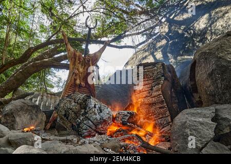 rustic lamb barbecue bbq over open fire in Patagonia, Argentina, South America. Asado is a Gaucho traditon with cooking on open flame Stock Photo