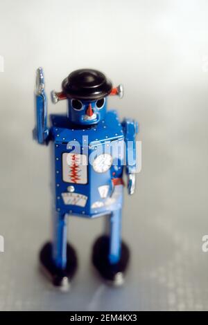 Antique robot tin toy still life on silver backdrop Stock Photo