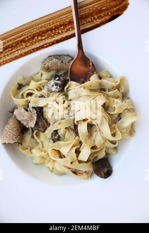 pasta with black truffles on wood background , Italian food Stock Photo