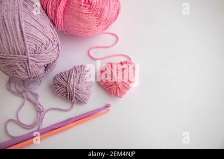 Threads,hooks, and two hearts lay on a white background.Holiday card, background. The concept of Valentine's Day, March 8, Mother's Day. Space for Stock Photo