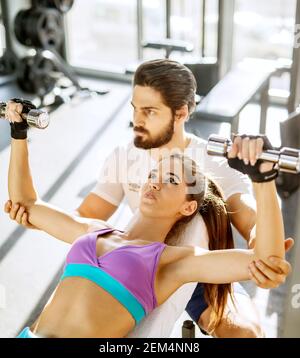 Beautiful woman doing chest exercises Stock Photo - Alamy