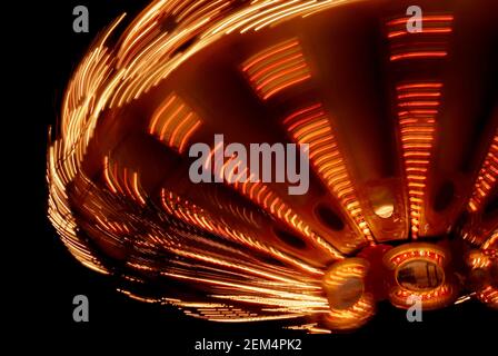 Close-up of a carousel spinning at night Stock Photo