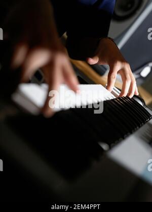 Close-up of a person's hands playing an electric piano Stock Photo