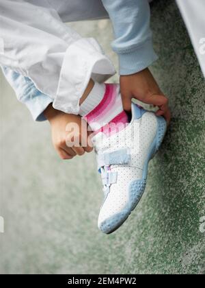 Low section view of a child putting on shoes Stock Photo