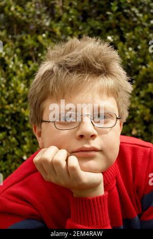 Portrait of a boy with his hand on his chin Stock Photo