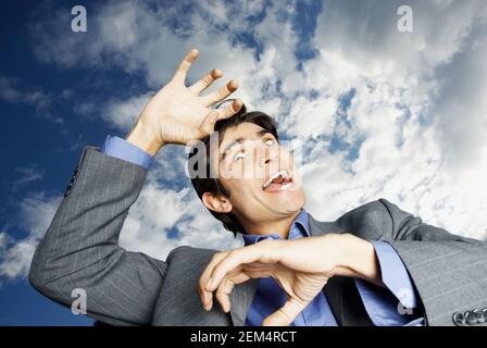 Low angle view of a mid adult man making a face Stock Photo