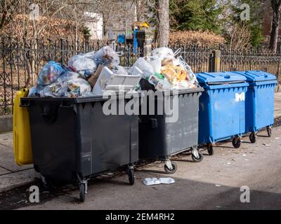 full garbage cans in the city Stock Photo