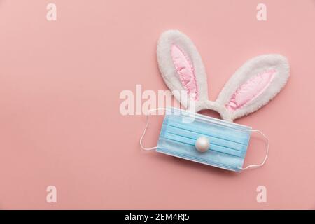 Coronavirus Easter bunny face made from rabbit ears and a protective face mask Stock Photo