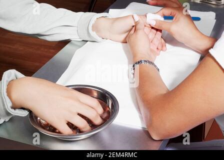 High angle view of a woman's hand getting a manicure Stock Photo