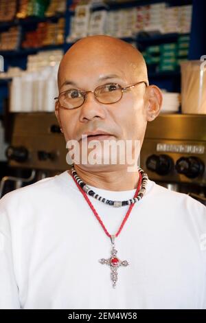 Portrait of a mature man wearing beads and crucifix Stock Photo