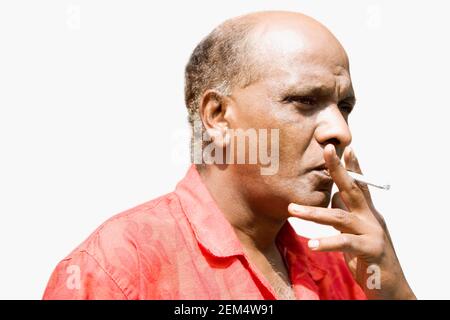 Close-up of a mature man smoking a cigarette Stock Photo
