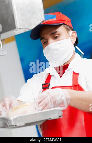 Close-up of a butcher weighing meat in a butcher shop Stock Photo