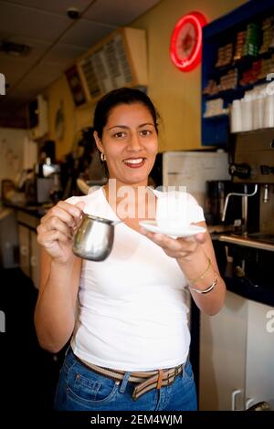 Portrait of a mid adult woman holding a mug and smiling Stock Photo