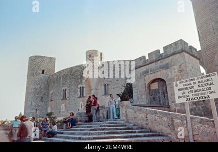 Archive scan of Palma Majorca approx 1975. A crowd gather outside of Bellver Castle, a medieval building high on a hilltop overlooking Palma Stock Photo