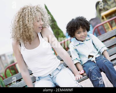 Two girls sitting on a bench Stock Photo