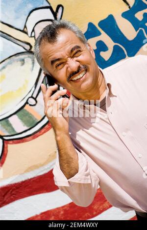 Portrait of a mature man using a mobile phone and smiling Stock Photo