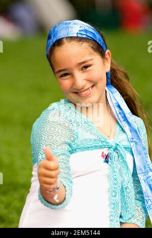 Portrait of a girl showing a thumbs up sign Stock Photo
